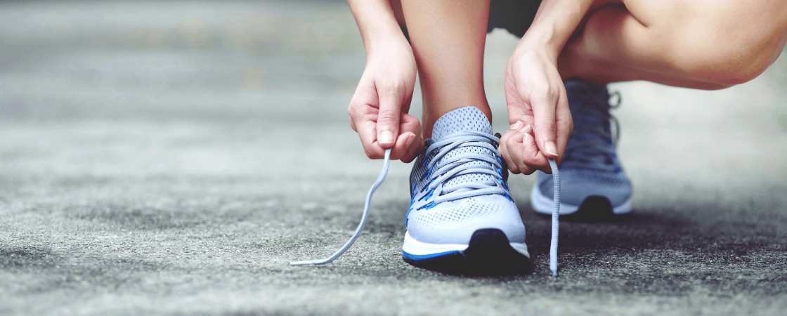 Woman putting on shoes for the gym